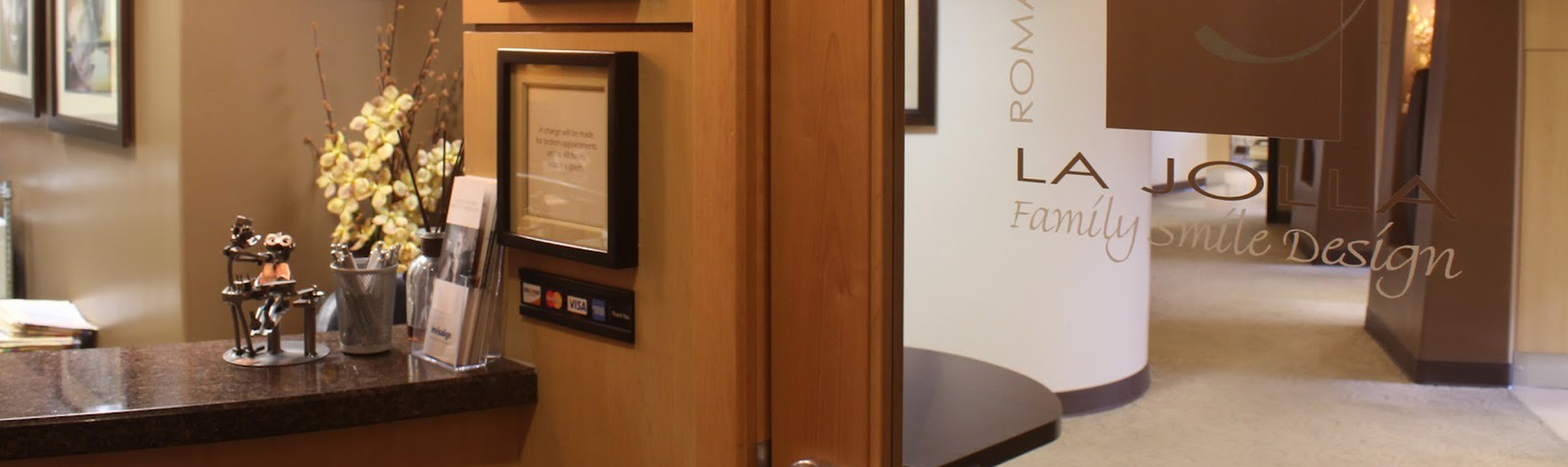 Modern dental office reception area with warm wood finishes and welcoming decor.